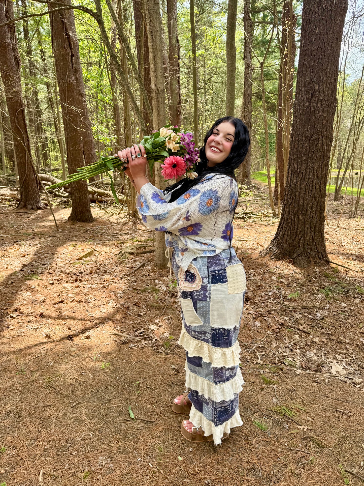 Woman holding flowers in a forest