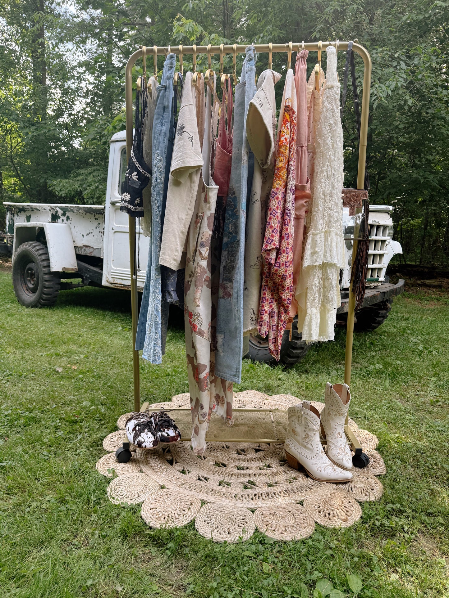 Collection of fabric rolls on a cart outdoors with a decorative table in the foreground.